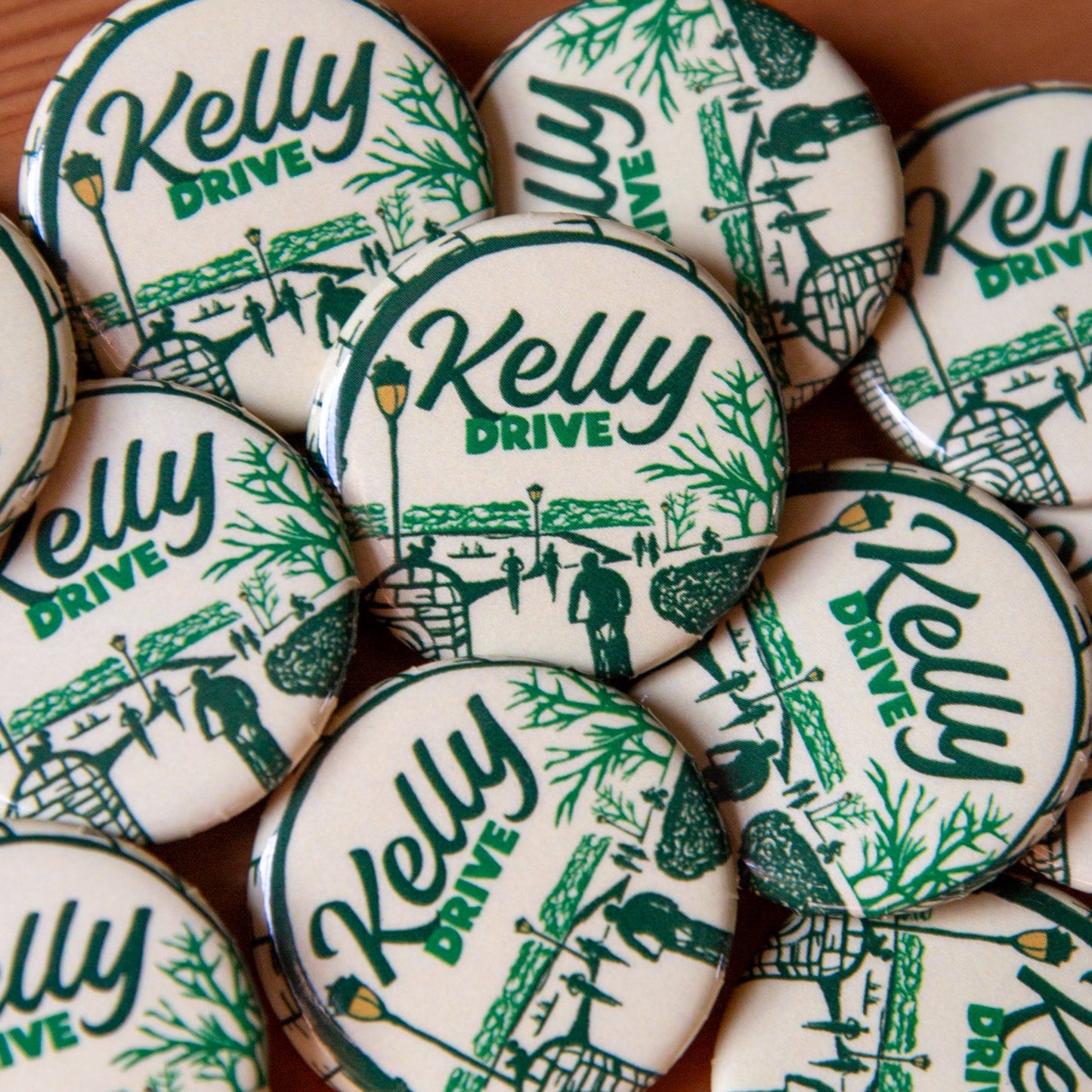 Collection of 'Kelly Drive' buttons on a wooden surface