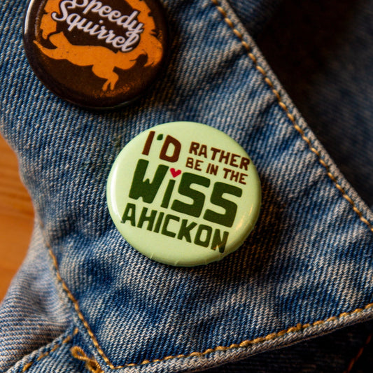 Green button on a denim jacket, with 'I'd Rather be in the Wissahickon' text