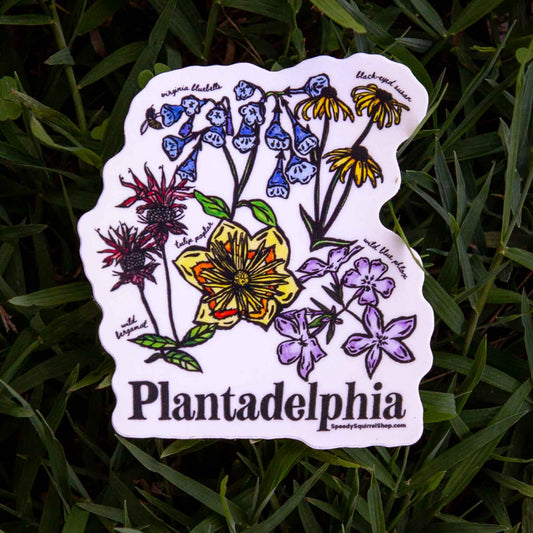 Sticker with floral design and 'Plantadelphia' text on grass
