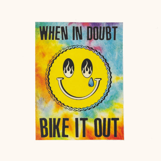 Colorful tie-dye poster with a smiley face and text 'When in doubt, bike it out' on a white background.