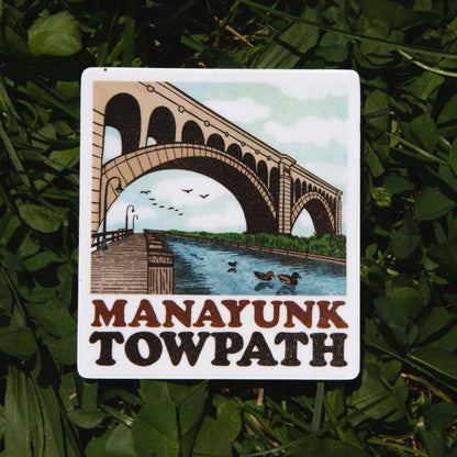 Sticker of Manayunk Towpath with a bridge and river design on grass