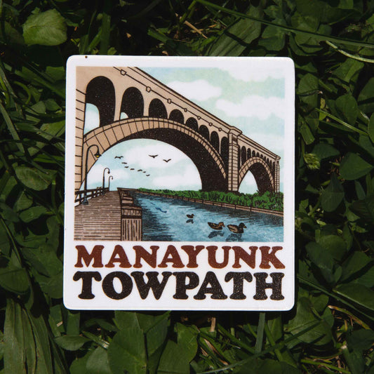 Sticker of Manayunk Towpath with a bridge and river design on grass