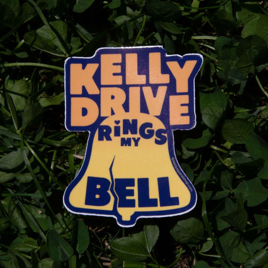 Sticker with 'Kelly Drive Rings My Bell' text on a grass background