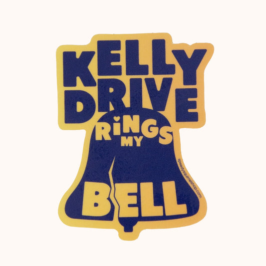 A blue and yellow waterproof vinyl sticker with the text 'KELLY DRIVE RINGS MY BELL' designed in the shape of a bell.