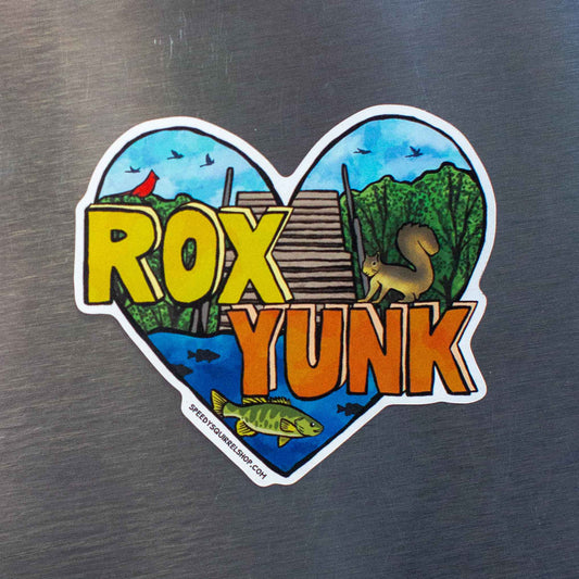 Heart-shaped sticker with 'ROX YUNK' text on a metallic surface