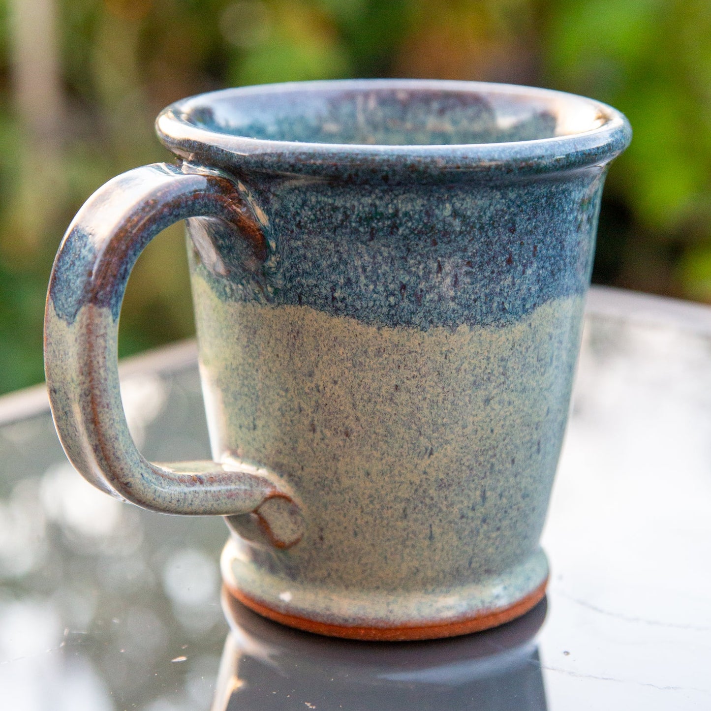 Back of handmade ceramic mug with blue gradient glaze. 