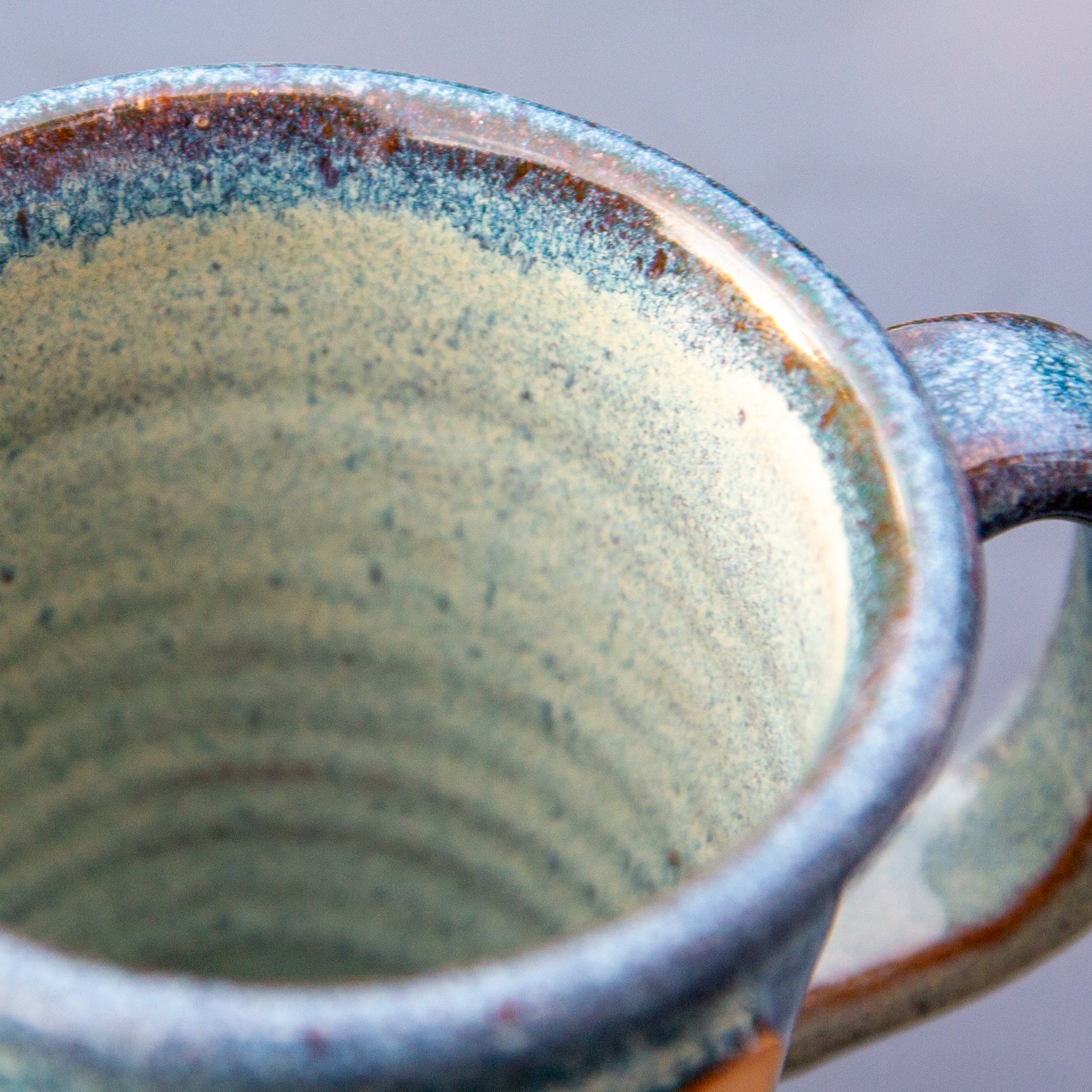 Close-up of a ceramic mug with a textured interior and handle.