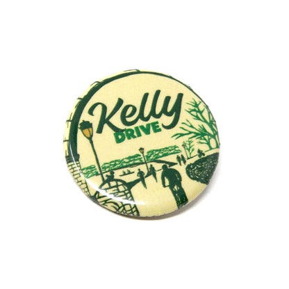 Round pin with 'Kelly Drive' text and green graphics on a white background