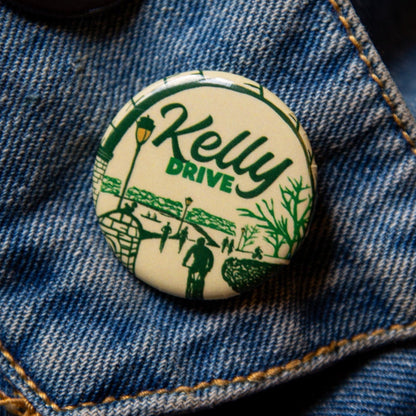 Button with 'Kelly Drive' design on a denim jacket