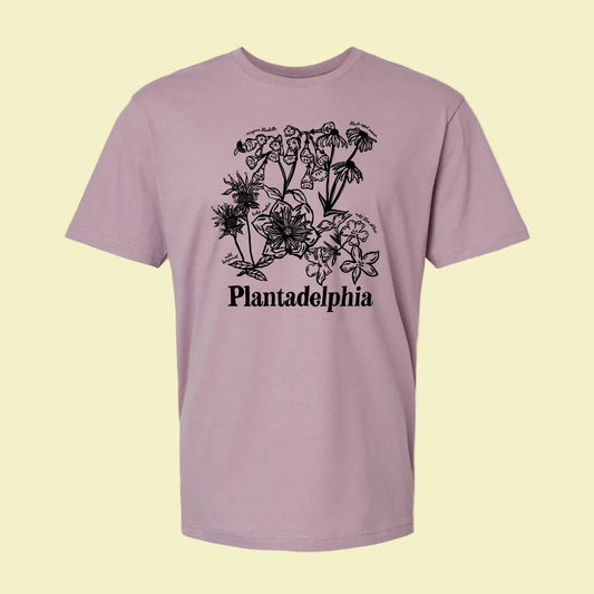 Purple t-shirt with black floral design and 'Plantadelphia' text on a yellow background