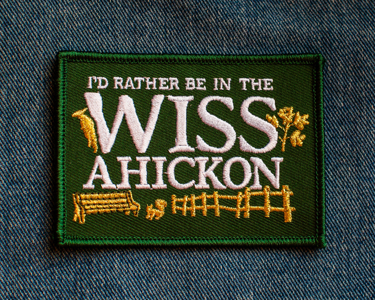 Embroidered patch with 'I'd Rather Be in the Wiss Ahickon' text on a denim background