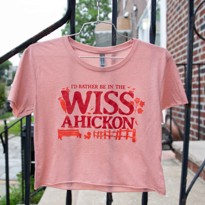 Pink crop with red text 'I'd Rather Be In The Wissahickon' on a hanger.