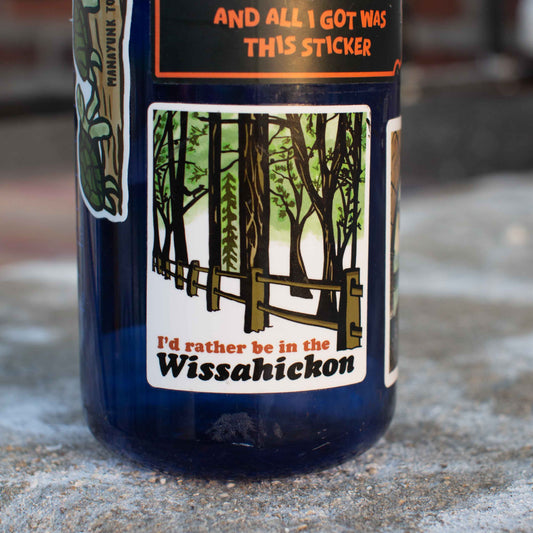 sticker with a forest design and text 'I'd rather be in the Wissahickon' on a blue water bottle.