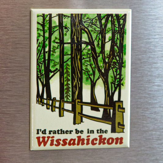 Fridge magnet with a forest design and text 'I'd rather be in the Wissahickon' on a metallic surface.