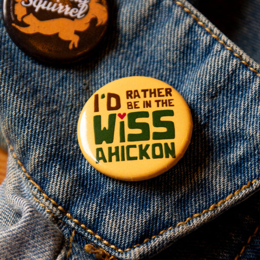 Yellow button on a denim jacket, with 'I'd Rather be in the Wissahickon' text